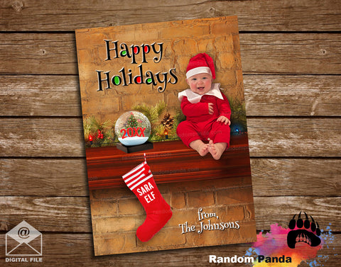 Christmas-themed card with a child in a Santa hat and elf outfit, featuring a stocking and 'Happy Holidays' text on a wooden background.