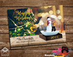 Gold Holiday card with snowman in a globe, Christmas lights, and 'Happy Holidays' text on a wooden background.