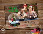 Personalized Funny Christmas holiday card with Parent's gaming while children trapped inside of a snow globe on a wooden background.