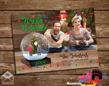 Personalized Funny Christmas holiday card with Parent's gaming while children trapped inside of a snow globe on a wooden background.