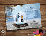 New Year's card with a snow globe design featuring a family and snowman, on a wooden surface.