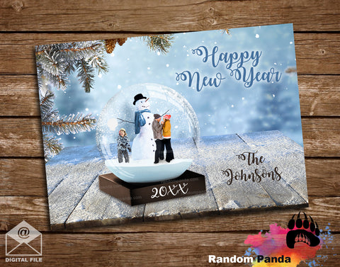 New Year's card with a snow globe design featuring a family and snowman, on a wooden surface.